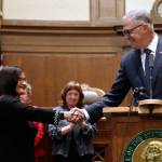 Whatcom County Superior Court Judge Raquel Montoya-Lewis, left, shakes hands with Gov. Jay Inslee after he introduced her as the newest member of the state Supreme Court on Wednesday in Olympia. (Elaine Thompson/The Associated Press)