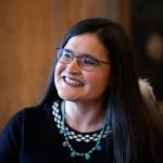 Whatcom County Superior Court Judge Raquel Montoya-Lewis, wearing an eagle feather honoring her Native American heritage, smiles as she speaks with media members after being named to the state Supreme Court on Wednesday in Olympia. (Elaine Thompson/The Associated Press)