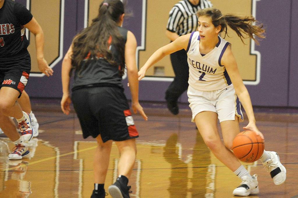 Sequims Jessica Dietzman (2) dribbles upcourt against Neah Bay forward Oceana Aguirre during the Wolves 86-63 win over Neah Bay on Wednesday. (Conor Dowley/Olympic Peninsula News Group)