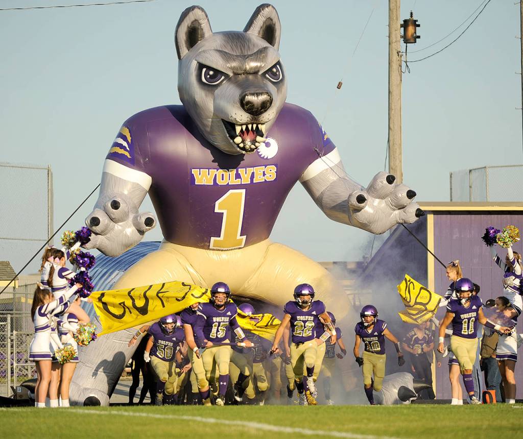 Sequim quarterback/defensive back Taig Wiker (15) and the Wolves take to the field before their first game of the season with Washington last September. (Michael Dashiell/Olympic Peninsula News Group)