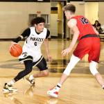 Peninsula Colleges Jaylin Reed (0) dribbles against Clackamas Michael Bashaw in Sundays Wilder Pirate Classic game in Port Angeles. Clackamas won 89-82. (Dave Logan/for Peninsula Daily News)