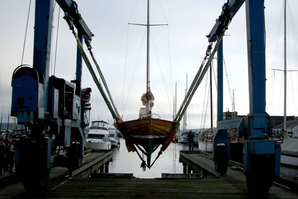 The Crysta Melanie, a sailboat that measures 19 feet, 2 inches long, is launched Monday at Point Hudson Marina in Port Townsend. (Brian McLean/Peninsula Daily News)