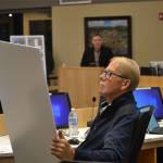 Sequim City Council member William Armacost looks at designs for the proposed Lavender Meadows development. (Matthew Nash/Olympic Peninsula News Group)