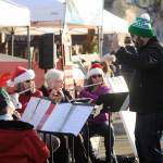 Director Tyler Benedict, right, pictured here leading the Sequim City Band in some festive holiday-themed tunes at the Home Town Holidays in downtown Sequim on Nov. 30, directs the band at the groups annual Joyous Sounds holiday concert set for 3 p.m. Sunday at the Sequim High School auditorium. (Michael Dashiell/Olympic Peninsula News Group)