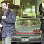 U.S. Marshals and Customs agents surround the car carrying suspected Algerian terrorist Ahmed Ressam in the garage of the Federal Courthouse in downtown Seattle on Friday, Dec. 17, 1999. Ressam was arrested Dec. 14, 1999, after taking a ferry to Port Angeles from Victoria with a trunkful of bomb-making materials in his car. Ressam was charged in federal court with bringing nitroglycerin into the United States, in addition to a charge of having false ID and making false statements to U.S. Customs officials. (Alan Berner/The Seattle Times via The Associated Press, file)