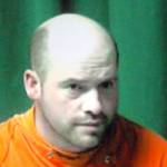 Keith Thorpe/Peninsula Daily News Ryan Warren Ward, 37, appears by video link during his first appearance in Clallam County Superior Court in Port Angels on Thursday on charges of aggravated first-degree murder with firearms enhancements related to a triple homicide in December.Inset in the two-way video appearance is Superior Court Judge Brian Coughenour.