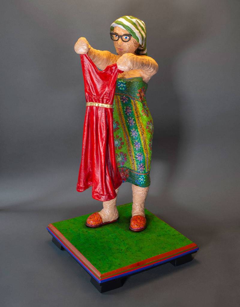 Drew Elickers Woman Looking at Dress is part of the Touching Color exhibit at the Ferguson Gallery inside the Jefferson Museum of Art & History. (Jefferson County Historical Society)