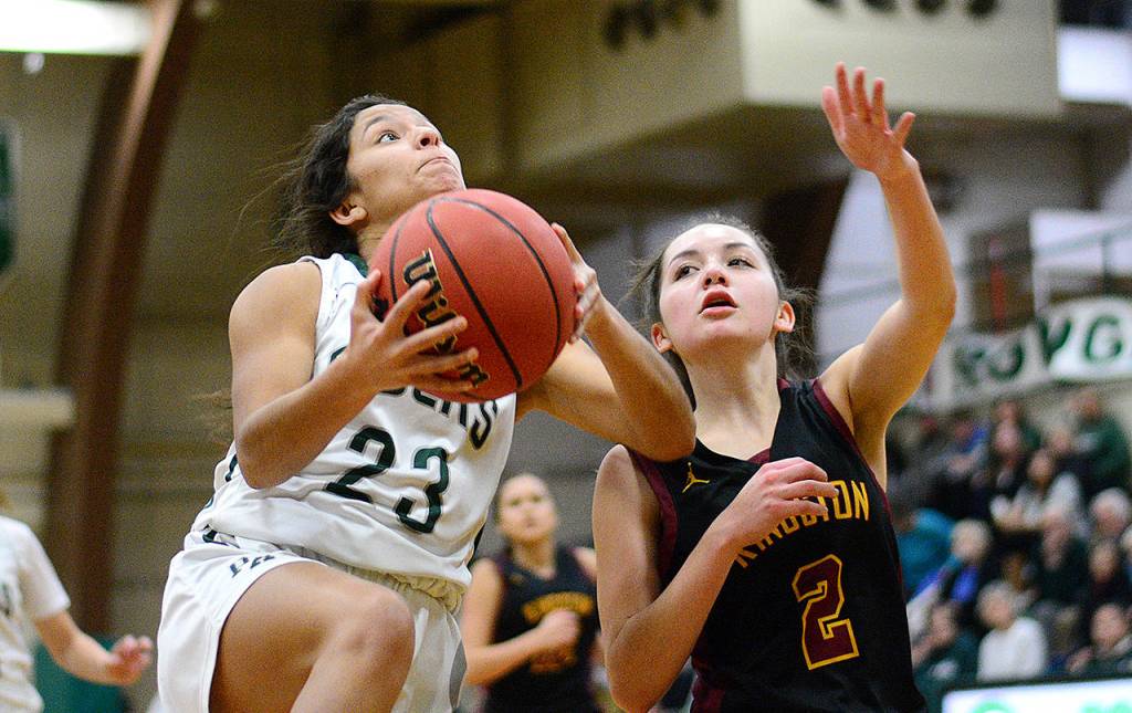 Jesse Major/Peninsula Daily News Port Angeles Camille Stensgard, left, goes up for a layup attempt while guarded by Kingstons Kylee Walker during the Roughriders 71-37 win on Friday.