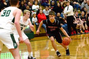 Neah Bays Julian Carrick runs past Port Angeles Riders during the first half of Port Angeles win over the Red Devils last week. (Jesse Major/Peninsula Daily News)