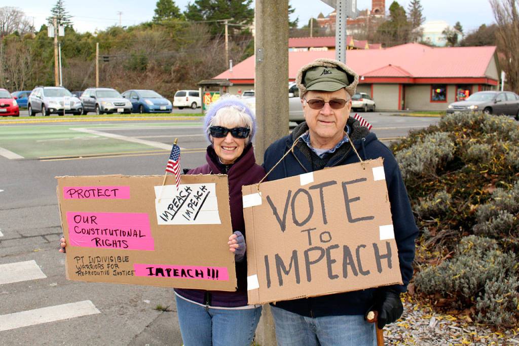 Rally organizer Michael Cornfoth, right, stands with Linda Martin during the Port Townsend Indivisible Groups rally supporting the impeachment of President Donald Trump.
