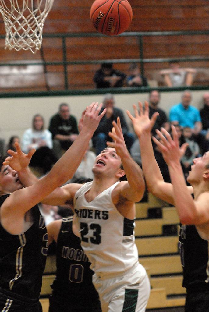 Port Angeles Anton Kathol, center, fights for a rebound with North Kitsap defenders, from left, Aiden Olmstead, Johny Olmsted and Logan Chmielewski on Wednesday night at Port Angeles High School. (Keith Thorpe/Peninsula Daily News)