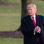 President Donald Trump glances at cheering White House visitors and claps his hands as as he leaves the White House for a campaign trip to Battle Creek, Mich. on Wednesday in Washington. (Manuel Balce Ceneta/The Associated Press)