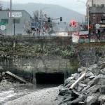 Water flows Thursday from an aging culvert that steers Peabody Creek into Port Angeles Harbor. (Keith Thorpe/Peninsula Daily News)