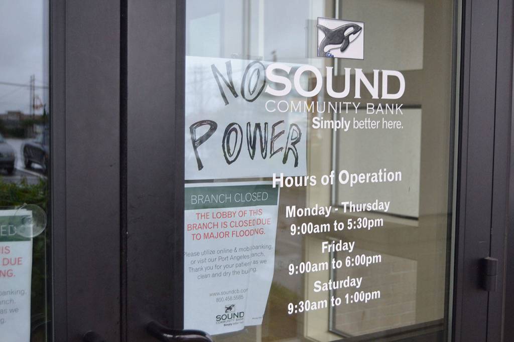 The front doors of Sequims Sound Community Bank let customers know they were closed with no power after a second flooding incident.