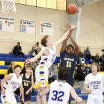 Trey Baysinger (11) of Forks goes up for a shot but Gabe Ritchie of Crescent tries to block it. Others watching are Crescents Brayden Emery (10), Tim Ward (32), and Mason Owens (22), and Forks Logan Olson (24). (Dave Logan/for Peninsula Daily News)