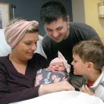 Parents Megan and Jon Lee of Port Angeles look at their newborn daughter, Maisie Miller Lee, the first baby in Clallam County for 2020, as Jack Lee, 5, admires his new sister at Olympic Medical Center on Wednesday. (Keith Thorpe/Peninsula Daily News)