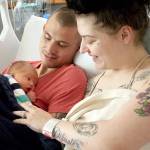 Casey McConaghy, left, holds his son, Mason Matthew McConaghy, next to his fiancée, Karma Hos, inside their room in the family birthing center at Jefferson Healthcare hospital. Mason was the first baby born in Jefferson County when he arrived six days early at 1:23 p.m. Jan. 1. (Brian McLean/Peninsula Daily News)
