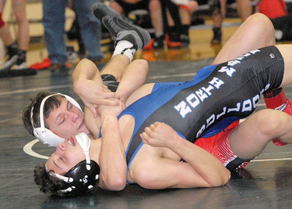 Keith Thorpe/Peninsula Daily News Port Townsends Logan Massie, top, attempts to pin Gabriel Espinosa of North Mason in their 145-lb. bout on Saturday in Port Angeles.