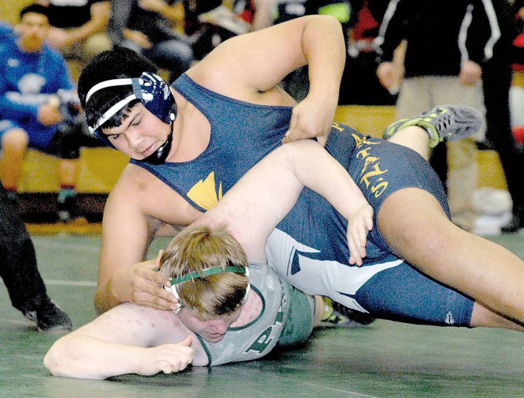 Keith Thorpe/Peninsula Daily News Forks Luis Maldonado-Rodriguez, top, takes on Port Angeles Jaymisen Morrison in the 285-lb. class at Saturdays Battle for the Axe at Port Angeles High School.