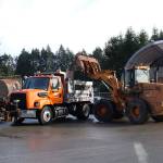 A large loader pours rock salt into the back of a salt truck and plow at the Jefferson County Public Works facility in Port Hadlock on Thursday as crews prepare for the possible snow in the upcoming days. (Zach Jablonski/Peninsula Daily News)