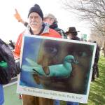 Doug Milholland of Port Townsend lines up on East Sims Way near the intersection with Kearney Street, along with about 100 people, on Thursday during the No War protest in Port Townsend. The event, organized by Indivisible Port Townsend, served as a demonstration against U.S. involvement in potential military action with Iran. (Brian McLean/Peninsula Daily News)