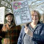 Cheri Van Hoover, left, and her sister, Leslie Payton of Port Ludlow participate in the No War protest on Thursday along with about 100 other people at the intersection of East Sims Way and Kearney Street in Port Townsend. The event, organized by Indivisible Port Townsend, served as a demonstration against U.S. involvement in potential military action with Iran. (Brian McLean/Peninsula Daily News)
