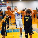 Elmas Jesus Torres, center, drives the lane while defended by Forks Tony Flores, left, and Iziah Morton, right during a 2018 game. The Forks Booster Club will raffle off a gift basket to benefit Torres, an Elma senior who is battling leukemia, at Fridays game in Forks. (Hasani Grayson/Grays Harbor News Group)