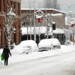 A pedestrian makes her way along a snow-covered Front Street in downtown Port Angeles on Wednesday after heavy snow blanketed the city overnight. (Keith Thorpe/Peninsula Daily News)