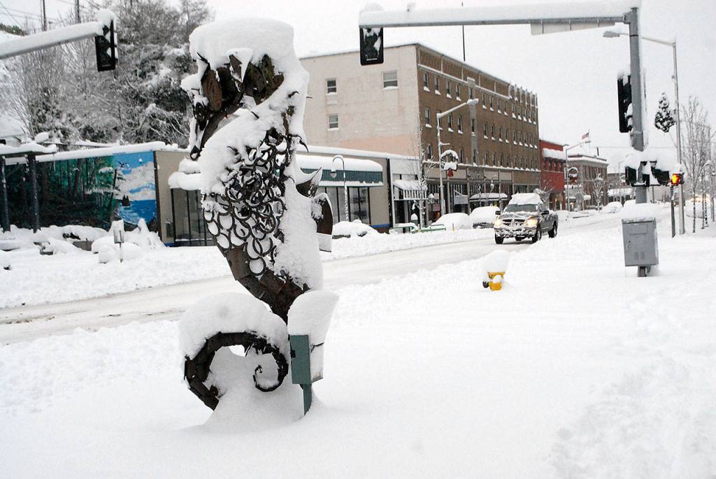 The Seahorse sculpture at First and Laurel streets stands with a drape of snow Wednesday morning in downtown Port Angeles. (Keith Thorpe/Peninsula Daily News)