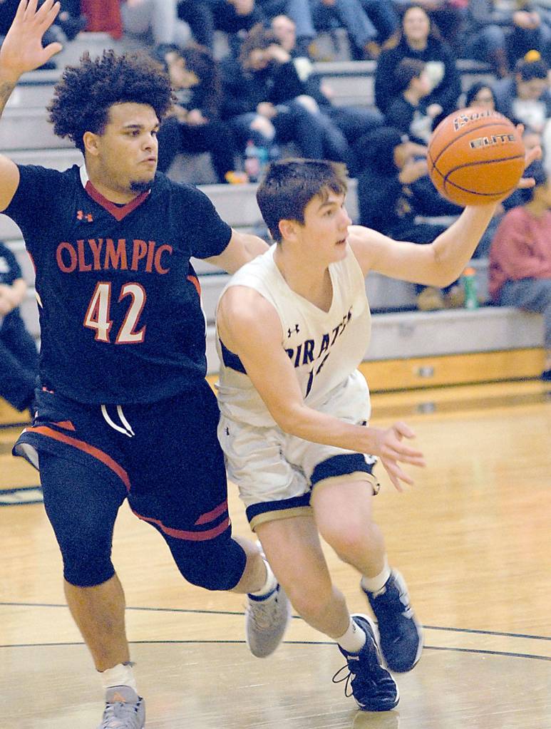 Peninsulas Gabe Long, a graduate of Port Angeles High School, right, slips around the defense of Olympics KaShon Tate on Saturday at Peninsula College. (Keith Thorpe/Peninsula Daily News)