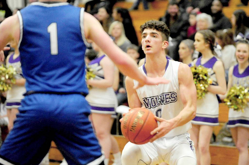Sequim guard Dallin Despain, right, sets up for a mid-range shot against North Mason on Wednesday. (Conor Dowley/Olympic Peninsula News Group)