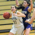 Keith Thorpe/Peninsula Daily News Port Angeles Eve Burke, left, drives to the lane as North Kitsaps Elizabeth Kimmel defends on Friday night in Port Angeles.