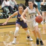 Keith Thorpe/Peninsula Daily News Bailee Larson of Port Angeles, right, drives downcourt pursued by North Kitsaps Mia McNair on Friday on the Roughrider court in Port Angeles.
