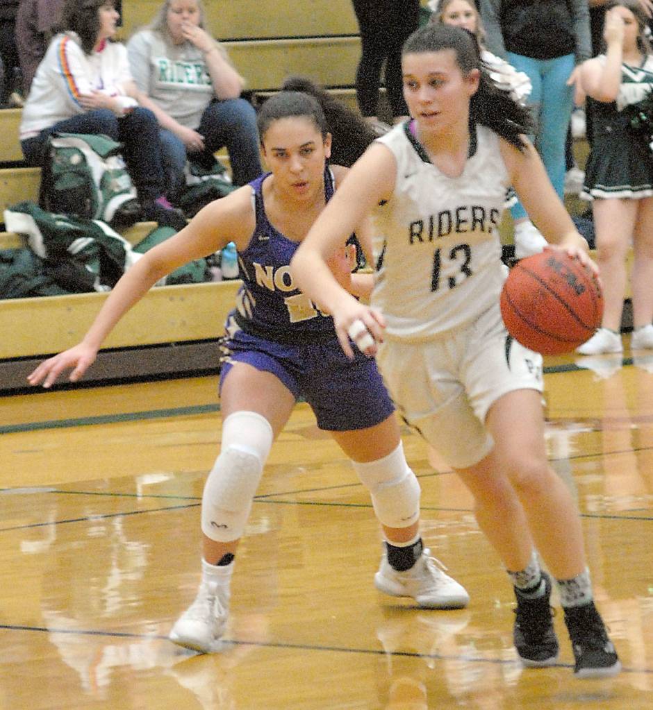 Keith Thorpe/Peninsula Daily News Bailee Larson of Port Angeles, right, drives downcourt pursued by North Kitsaps Mia McNair on Friday on the Roughrider court in Port Angeles.