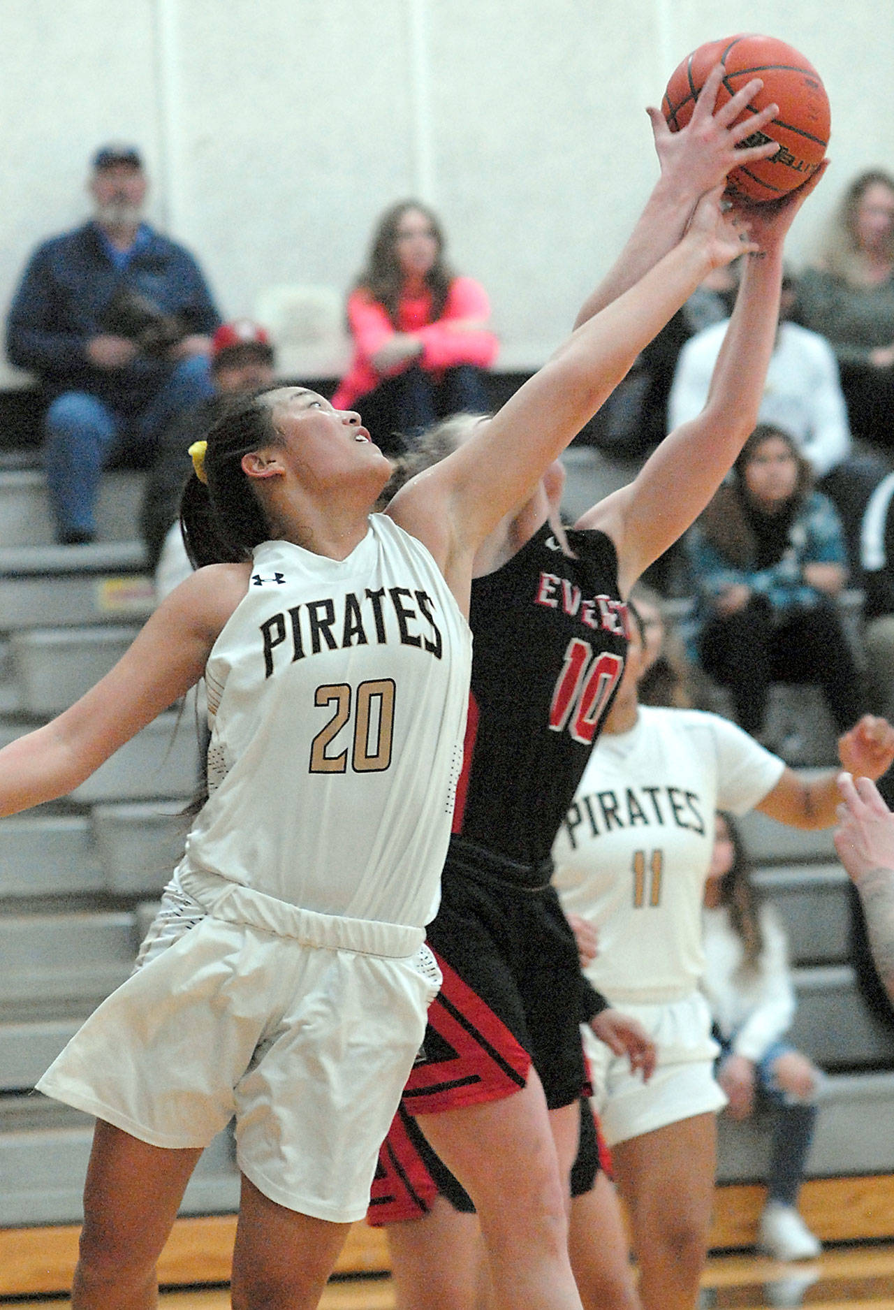 Keith Thorpe/Peninsula Daily News Peninsulas Logan Luke, front, and Everetts Morgan Marshall fight for a rebound on Saturday evening in the Peninsula College gym.