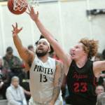 Keith Thorpe/Peninsula Daily News Peninsulas Marquis Gurske, left, goes for a shot as Everetts Devin Smith tries to deflect during Saturday nights matchup at Peninsula College in Port Angeles.