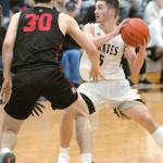 Keith Thorpe/Peninsula Daily News Peninsulas Nate DeSpain, right, looks to pass as Everetts Bobby Martin closes in during first-half play on Saturday in Port Angeles.