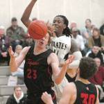 Keith Thorpe/Peninsula Daily News PeninsulasMalik Moore, top, battles for a rebound with Everetts Devin Smith, front, and Bobby Martin on Saturday in Port Angeles.