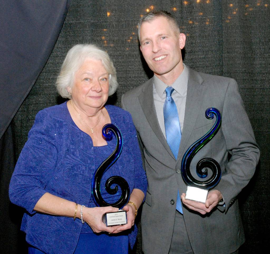 Port Angeles Regional Chamber of Commerce Legacy Award winners Marie Moran, representing her husband, the late Port Angeles City Council Member Jim Moran, and Rian Anderson, a partner with Black Ball Ferry, display their awards on Saturday at Vern Burton Community Center. (Keith Thorpe/Peninsula Daily News)