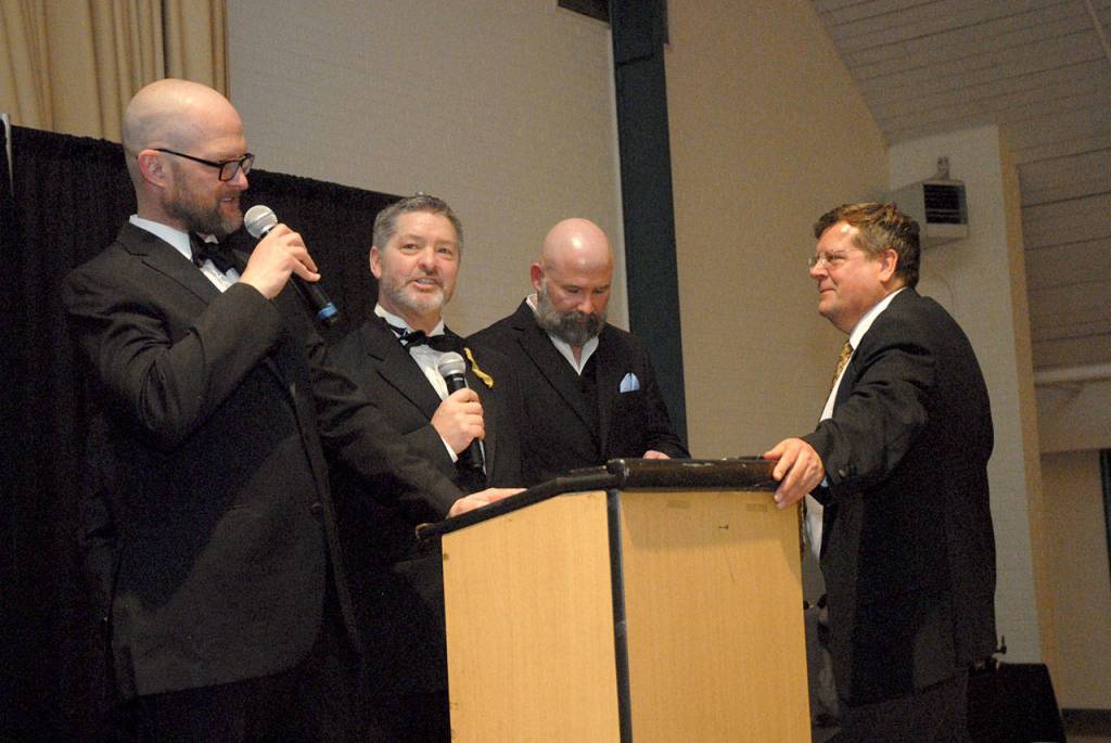 Community Award and Legacy Award presenters, from left, Josh Jones, Tim Tucker, Terry Ward and Marc Abshire talk at the conclusion of Saturdays ceremony. (Keith Thorpe/Peninsula Daily News)