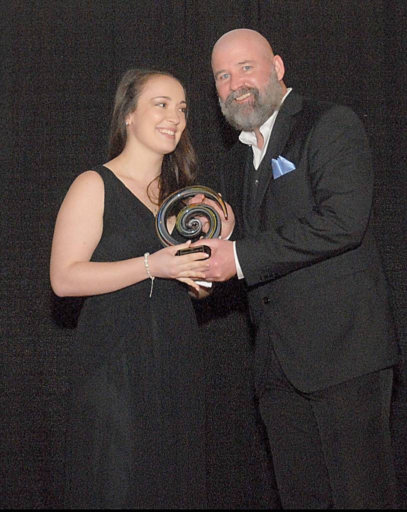 Salina Treider, owner of Studio360, accepts the Emerging Business of the Year award from award sponsor Terry Ward, publisher of the Peninsula Daily News. (Keith Thorpe/Peninsula Daily News)