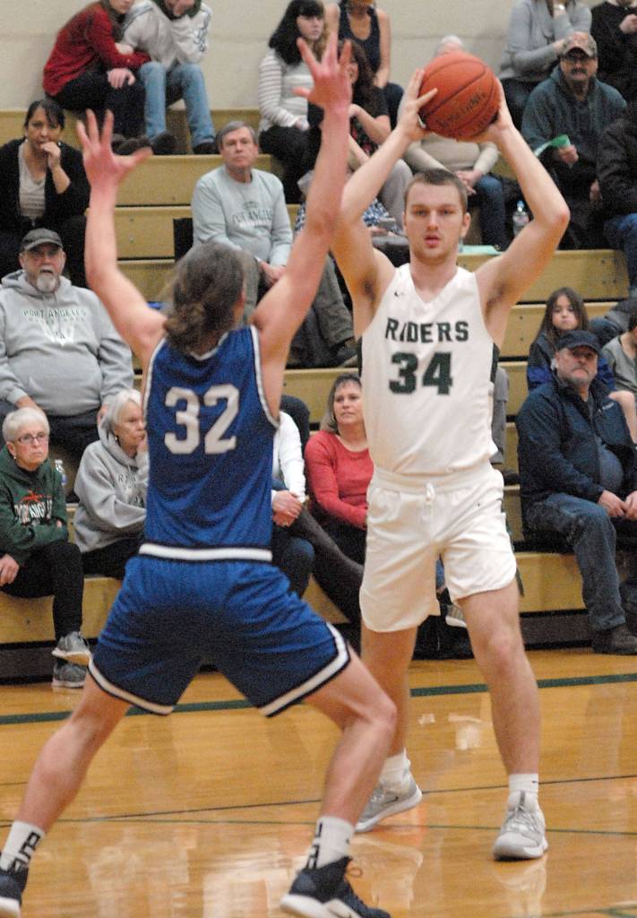 Port Angeles Lucas Jarnagin, right, looks to pass around the defense of North Masons Spencer Davis on Tuesday, Jan. 28, 2020, at Port Angeles High School. (Keith Thorpe/Peninsula Daily News)