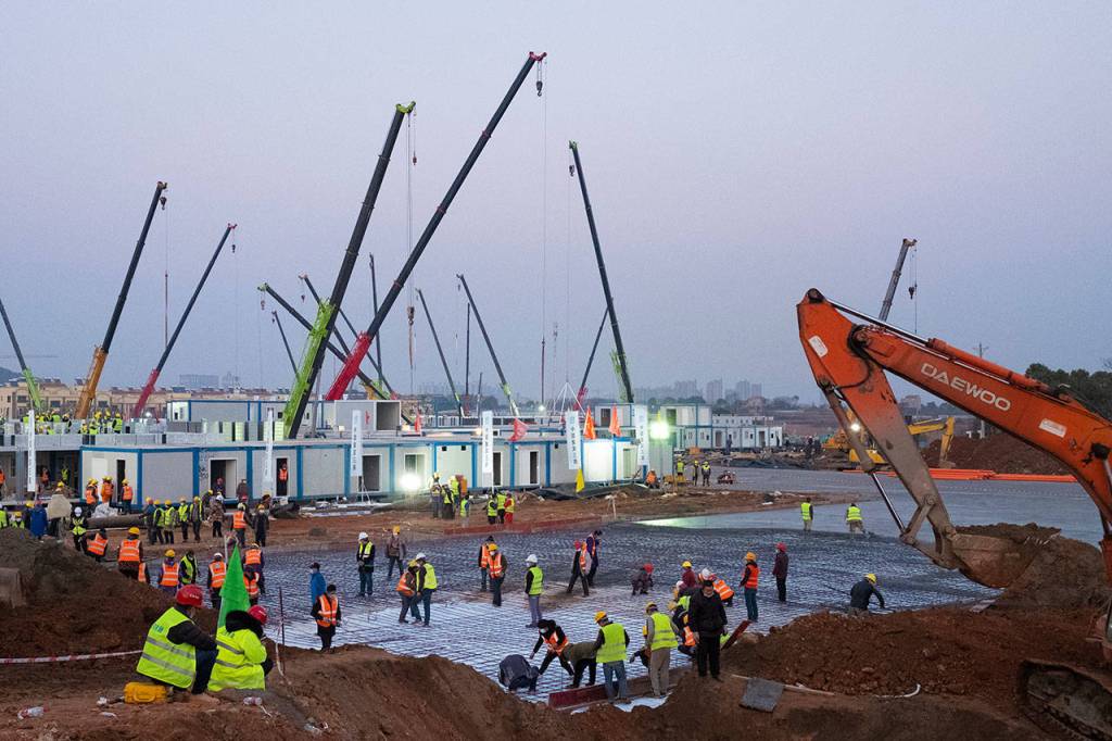 Construction workers labor at the site of the Huoshenshan temporary field hospital being built in Wuhan in central Chinas Hubei Province, Thursday, Jan. 30, 2020. (AP Photo/Arek Rataj)