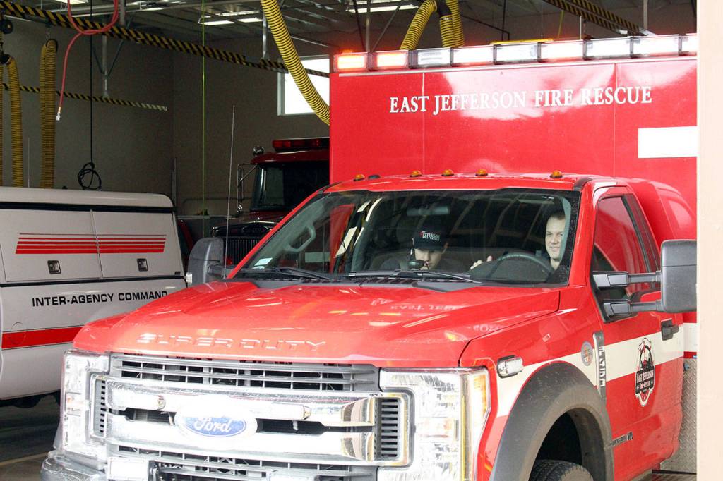 East Jefferson Fire Rescue Lt. Reece Chambers, left, and resident firefighter/EMT Matt Kaldahl leave the Chimacum Fire Station on Friday morning to respond to a medical call on Marrowstone Island. (Zach Jablonski/Peninsula Daily News)