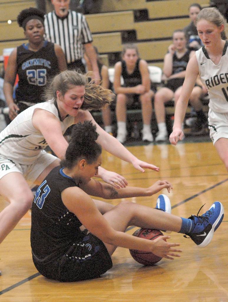 Keith Thorpe/Peninsula Daily News Port Angeles Myra Walker, left, scrambles for a loose ball with Olympics Aaliyah Williams as Port Angeless Millie Long, right, prepares to dive in during Friday Nights game at Port Angeles High School.