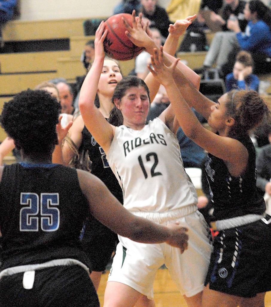 Keith Thorpe/Peninsula Daily News Port Angeles Ava Brenkman, center, is surrounded by Olympic defenders, from left, Kaylani Riley, Elisa Turnquist and Amiya Jameson, on Friday night at Port Angeles High School.