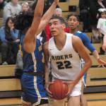 Damen Ringgold of Port Angeles, right, is defended in the lane by Bremertons Kimo Retome during Tuesday nights Olympic League game in Port Angeles. (Keith Thorpe/Peninsula Daily News)