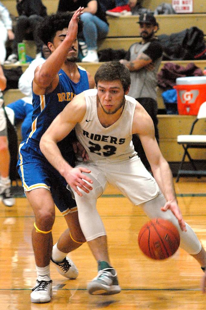 Port Angeles Anton Kathol, right, drives past Bremertons Kaipo Retome on Tuesday at Port Angeles High School. (Keith Thorpe/Peninsula Daily News)