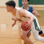 Port Angeles Chase Cobb is grabbed by Bremertons DAngelo Moore to draw the foul on Tuesday in Port Angeles. (Keith Thorpe/Peninsula Daily News)