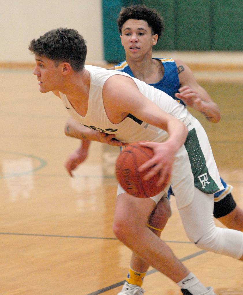 Port Angeles Chase Cobb is grabbed by Bremertons DAngelo Moore to draw the foul on Tuesday in Port Angeles. (Keith Thorpe/Peninsula Daily News)
